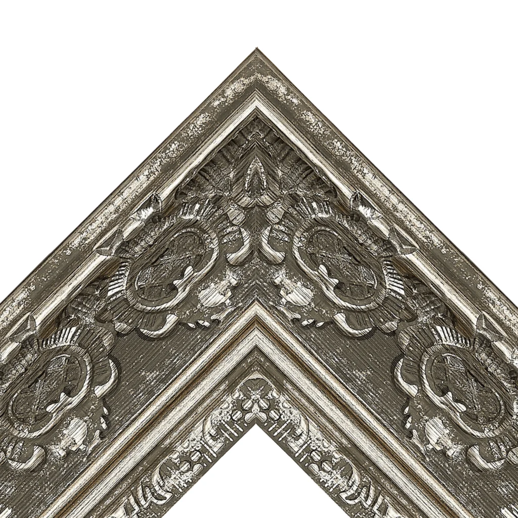 Corner detail of an antique ornate decorative TV frame with distressed silver finish and carved patterns