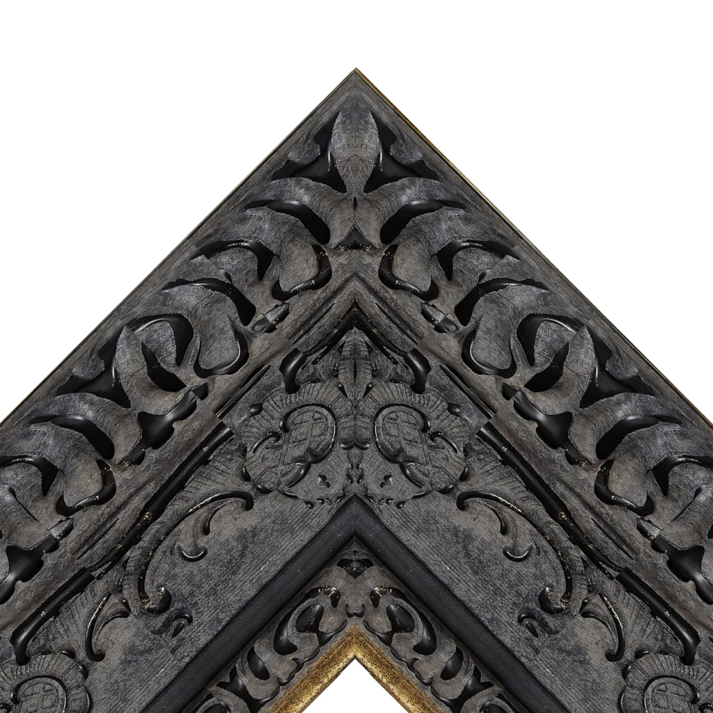 Dark ornate TV frame corner with carved gothic decorative pattern